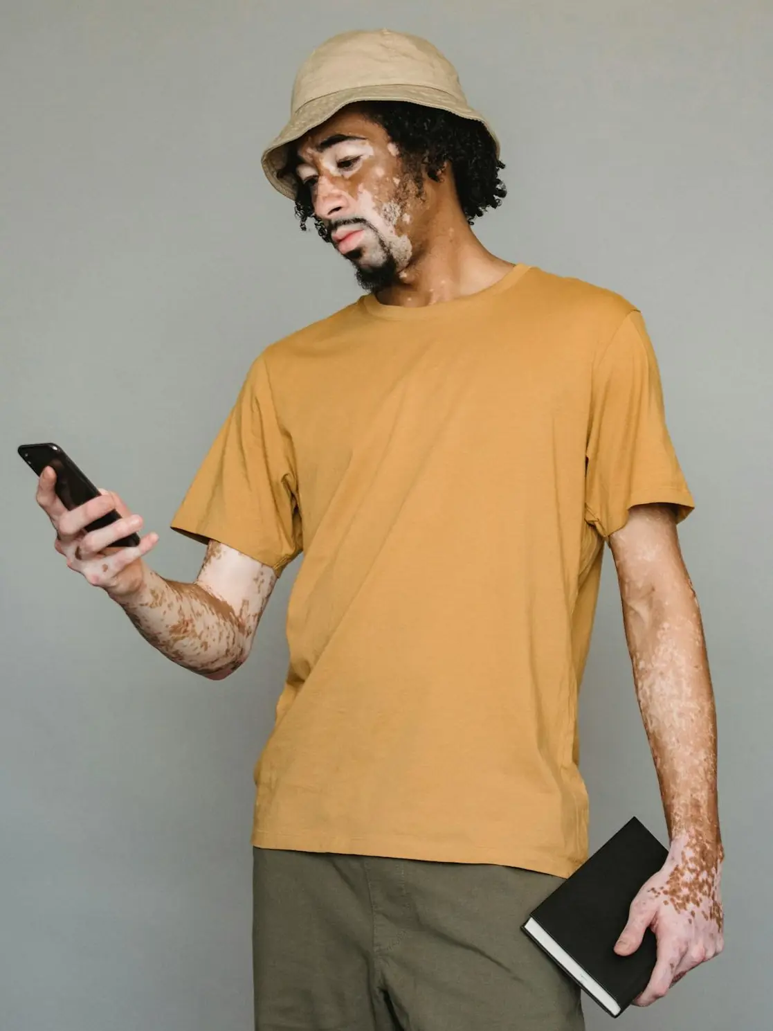 Serious black man browsing smartphone in studio Pexels Armin Rimoldi
